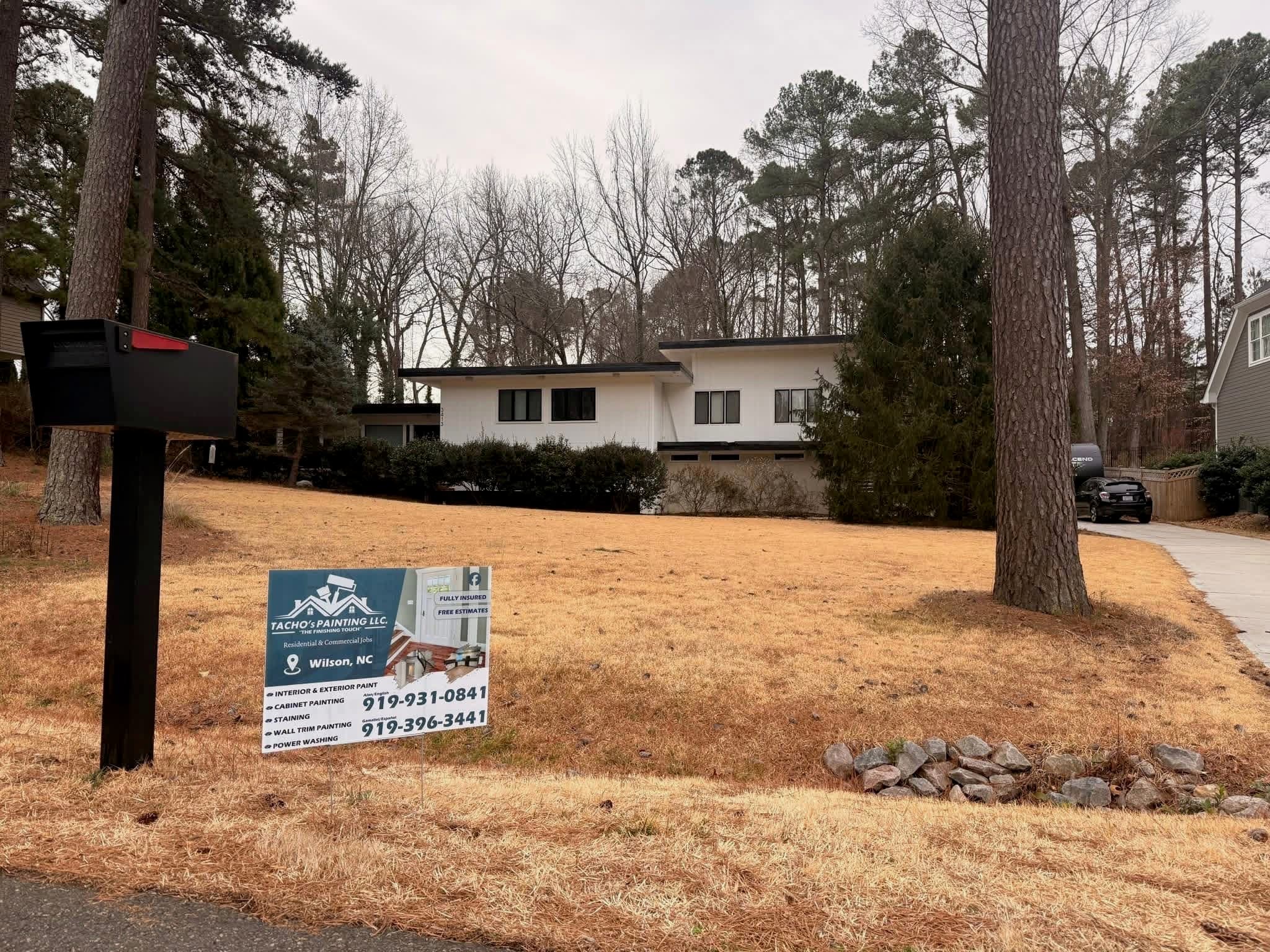 Completed exterior repaint with Tacho Painting LLC yard sign in Wilson NC